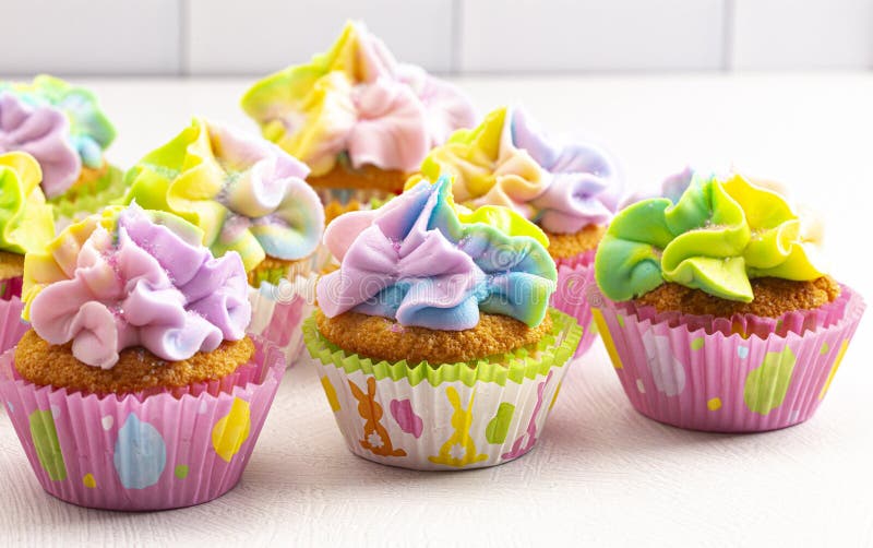 Pastel Rainbow Frosted Easter Cupcakes on a Kitchen Counter Stock Image