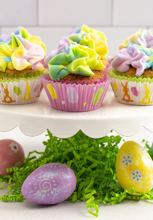 Pastel Rainbow Frosted Easter Cupcakes on a Kitchen Counter Stock Image