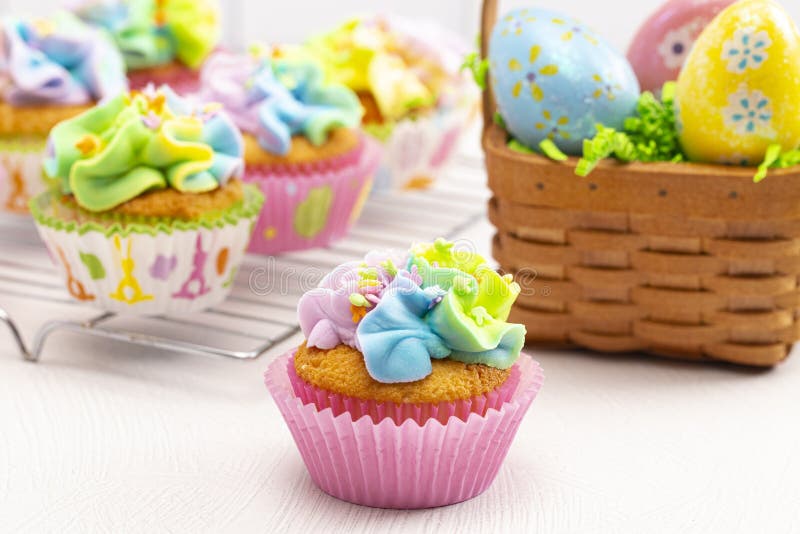 Pastel Rainbow Frosted Easter Cupcakes on a Kitchen Counter Stock Image