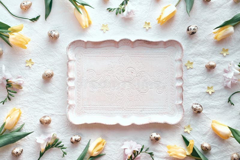 Pastel serving tray centered on a white background surrounded by yellow tulips and quail eggs for Easter vector illustration