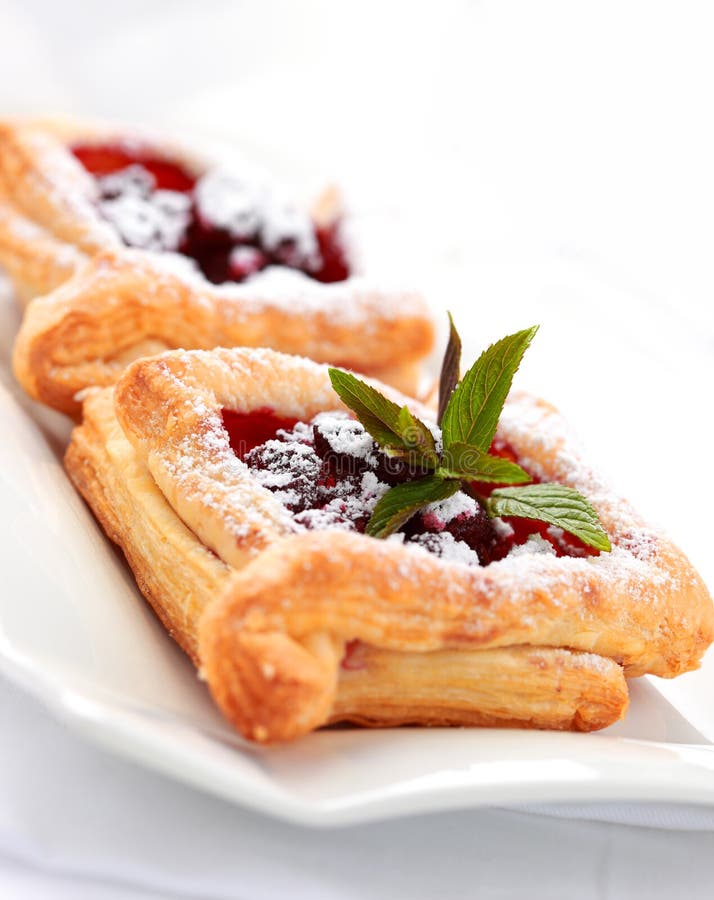 Delicious Cherry puff pastry with powdered sugar. Delicious Cherry puff pastry with powdered sugar