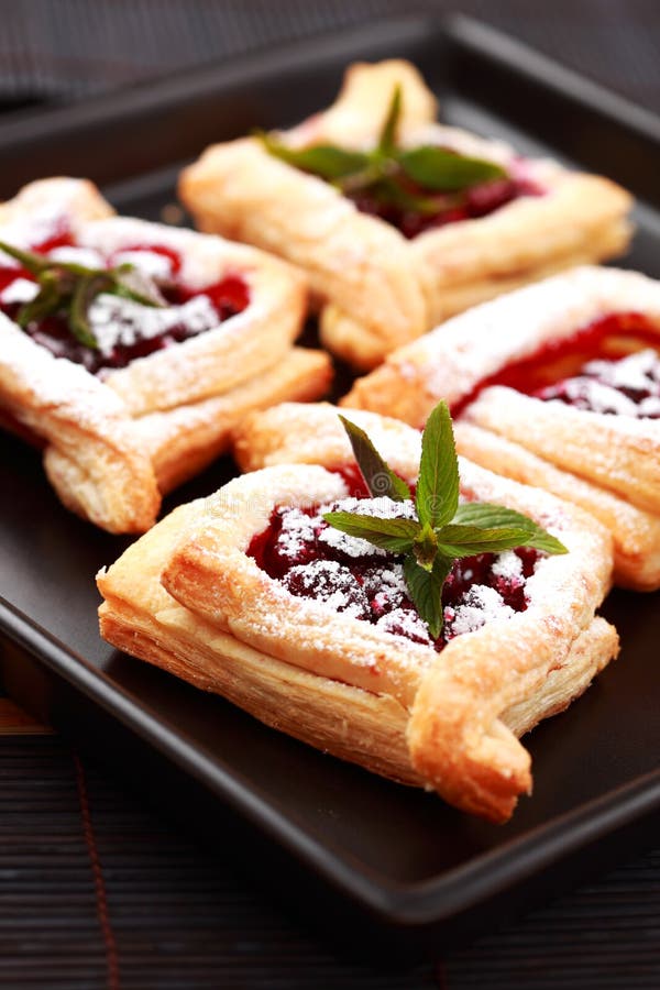 Delicious Cherry puff pastry with powdered sugar. Delicious Cherry puff pastry with powdered sugar