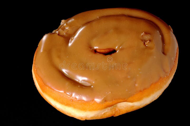 Old fashioned type donut maple pastry over black. Old fashioned type donut maple pastry over black