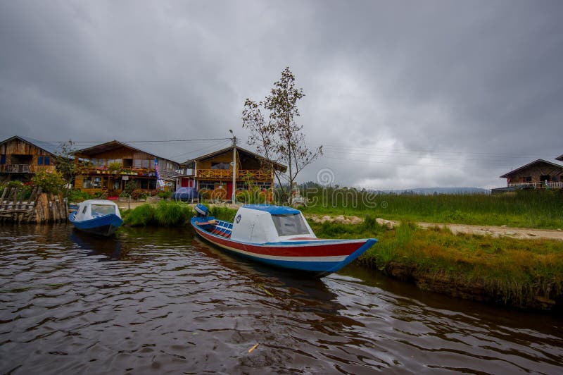 PASTO, COLOMBIA - JULY 3, 2016: some colorfull boats parked at the shore of la cocha lake