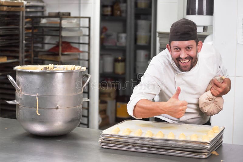 Pastry Chef with Confectionary Bag Squeezing Cream at Pastry Shop