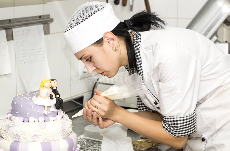 Pastry chef decorates a cake