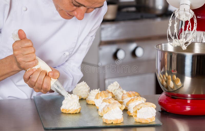 Pastry chef decorating stock image. Image of cooked, kneading 74731509