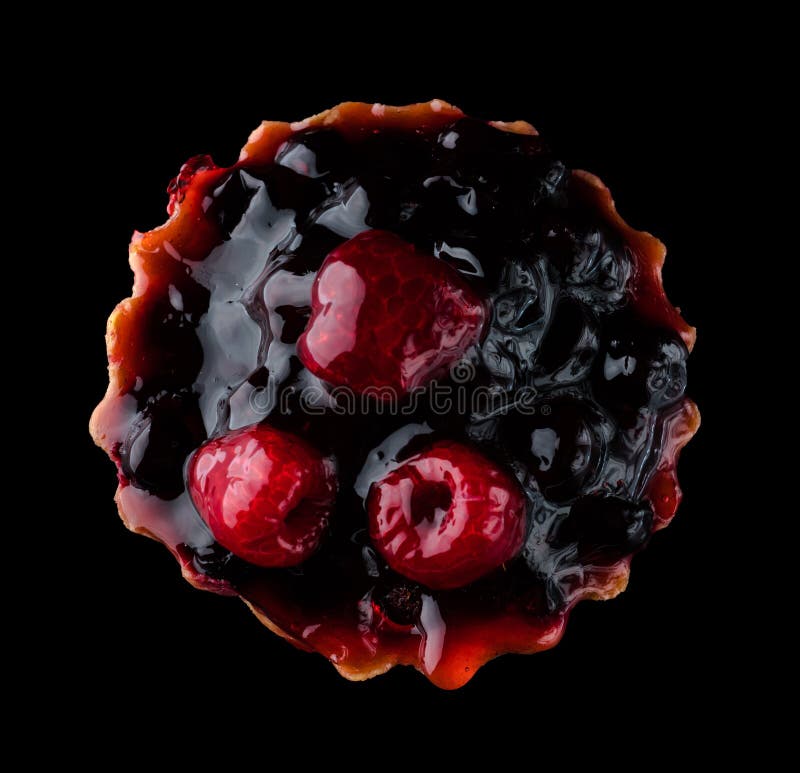 Pastry stuffed with fruits, berries and citrus fruits on a black background in isolation, view from the top, confectionery product