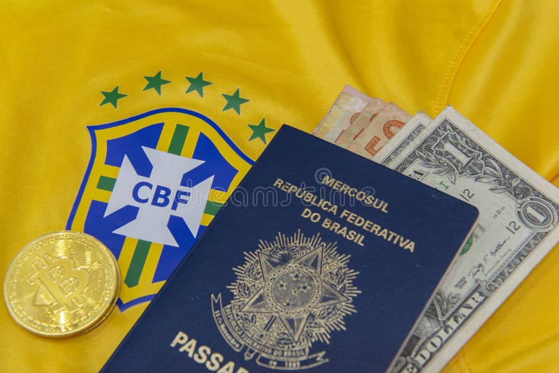 Bauru, Brazil - 11.01.23: Brazilian Football Confederation emblem on football jersey. Soccer players sale and trading concept. Passport and money from fans or players on the Brazilian team t-shirt. Bauru, Brazil - 11.01.23: Brazilian Football Confederation emblem on football jersey. Soccer players sale and trading concept. Passport and money from fans or players on the Brazilian team t-shirt