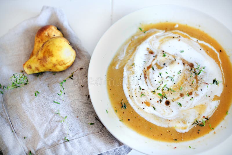 Patata dolce e minestra cremosa della rutabaga con le pere, erbe immagini stock Patata dolce e minestra cremosa della rutabaga con le pere, erbe immagini stock