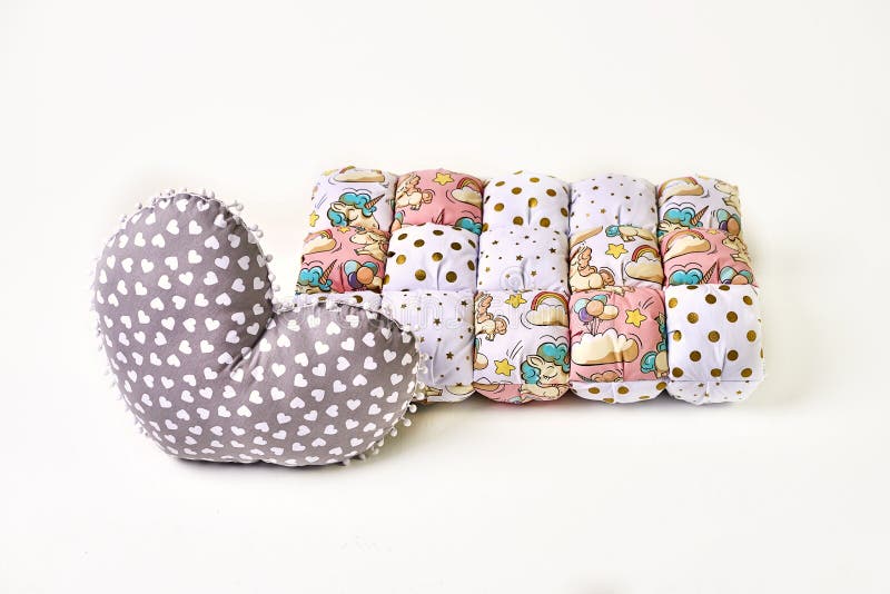 Patchwork comforter and heart shaped pillow on white backgroun. stock photos