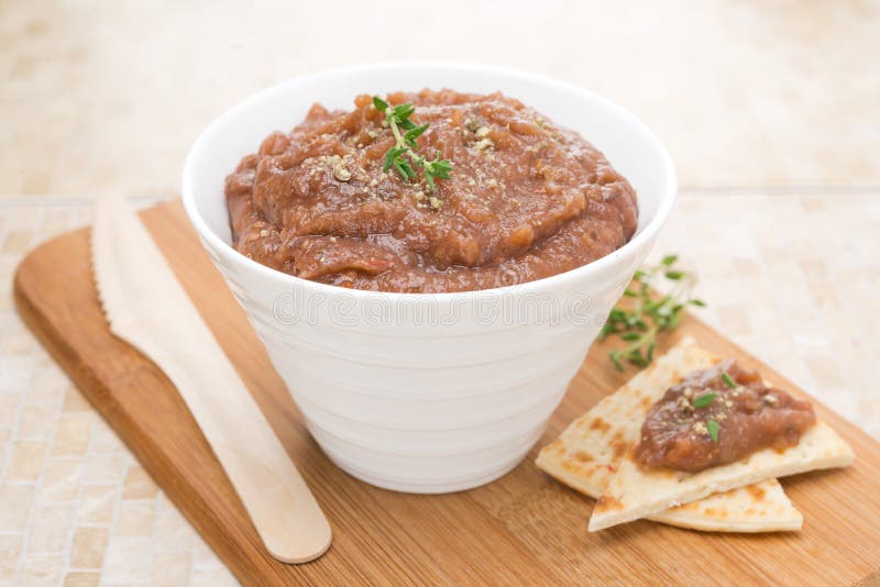 Pate of roasted eggplant and tomatoes on a wooden board