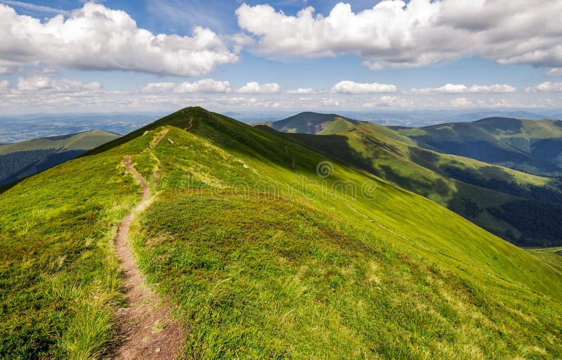 Path through the grassy mountain ridge