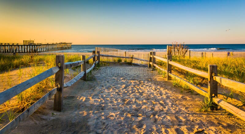 Path over sand dunes to the Atlantic Ocean at sunrise in Ventnor City, New Jersey.