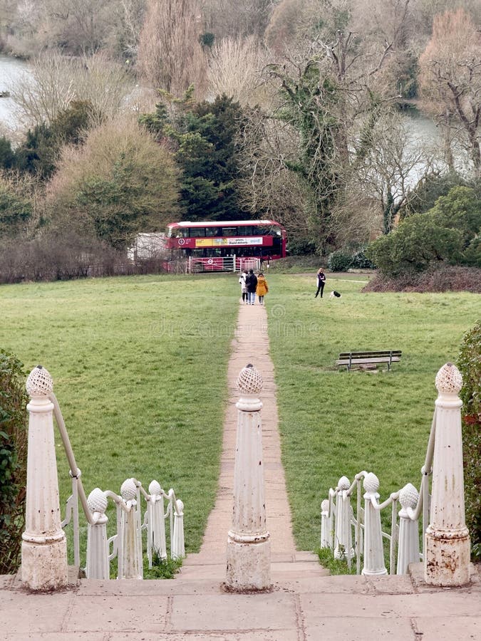 Pathway in park with red double-decker bus. royalty free stock photo