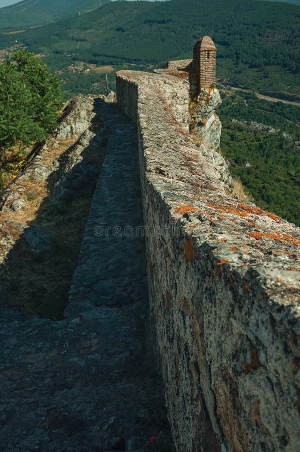 Pathway on stone wall with watchtower over ridge in Marvao stock photo Pathway on stone wall with watchtower over ridge in Marvao stock photo