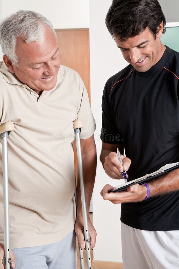 Patient on Crutches and Physician Stock Photo Image of people