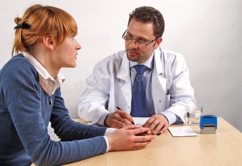 Doctor and woman patient talking to each other. Negotiating table stock images, royalty-free photos and pictures