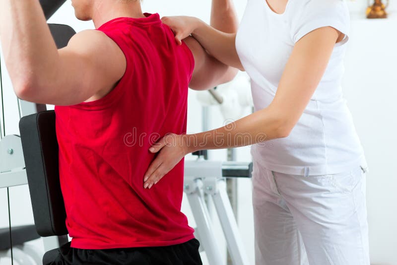 Patient at the physiotherapy making physical exercises with his therapist