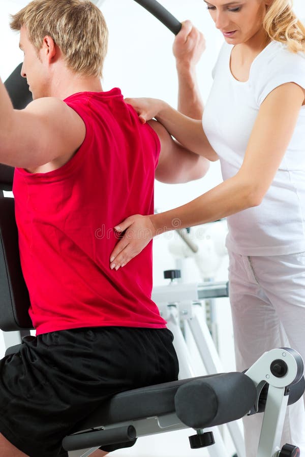 Patient at the physiotherapy making physical exercises with his therapist