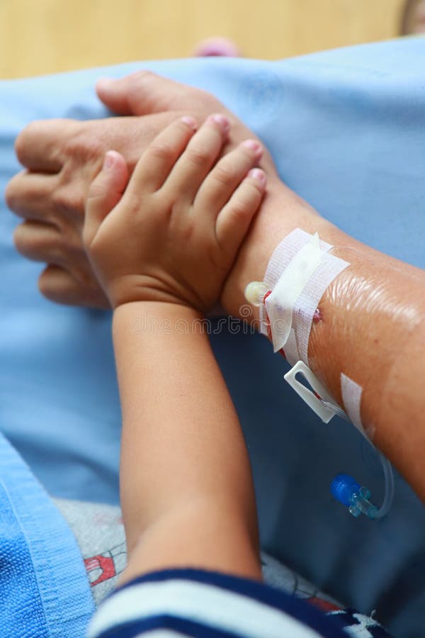 Patient`s Arm With Plastic Infusion Set And Kids Hand Holding A Patient