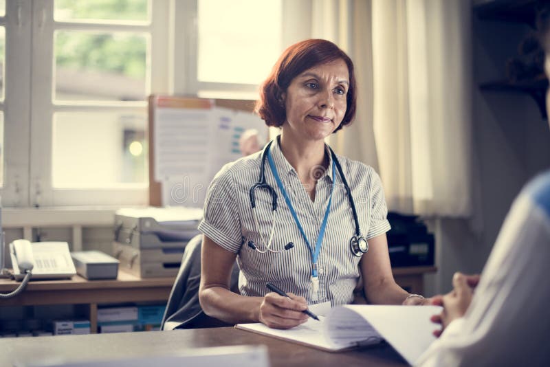 Patient som möter en doktor i klinik royaltyfri fotografi Patient som möter en doktor i klinik royaltyfri fotografi