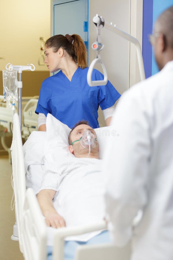 Patient on Stretcher Being Pushed by Nurse Stock Photo Image of