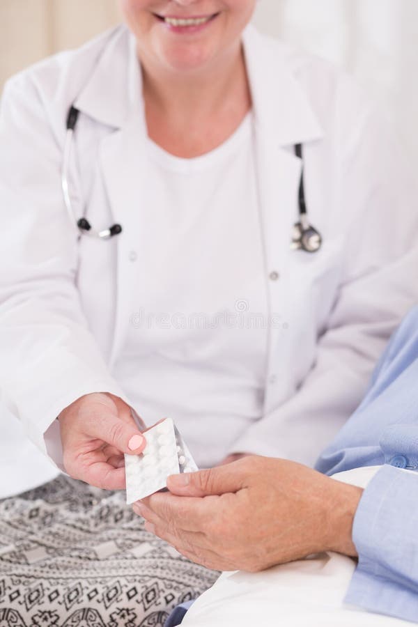Patient taking pills from nurse royalty free stock image