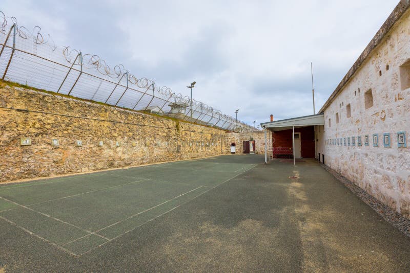 courtyard with barbed wire of Fremantle Prison historic building, UNESCO World Heritage and one of most notorious prisons in British Empire. Fremantle is port city of Perth in Western Australia. courtyard with barbed wire of Fremantle Prison historic building, UNESCO World Heritage and one of most notorious prisons in British Empire. Fremantle is port city of Perth in Western Australia.