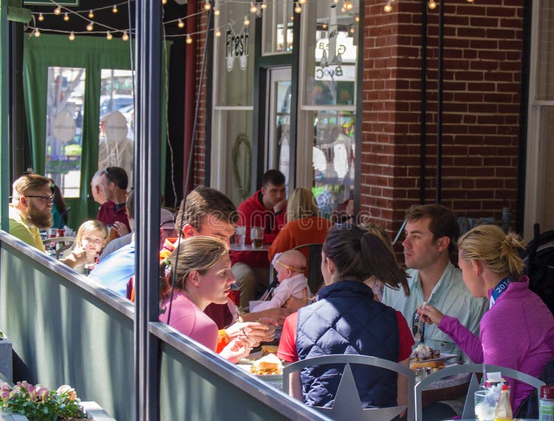 Roanoke, VA â€“ April 16th: Families enjoying lunch at an outdoor patio restaurant located at the Market Building in Roanoke, Virginia, USA on April 16th, 2016. Roanoke, VA â€“ April 16th: Families enjoying lunch at an outdoor patio restaurant located at the Market Building in Roanoke, Virginia, USA on April 16th, 2016.
