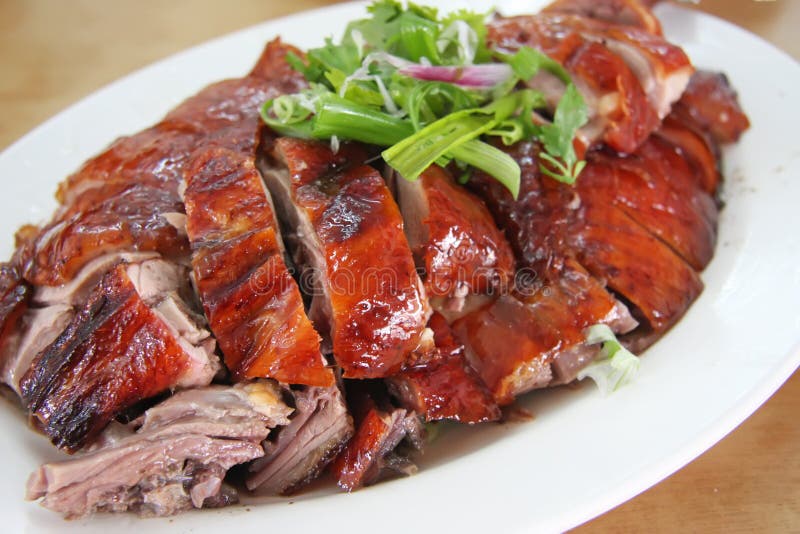 Roast duck chinese cuisine sliced portions on plate. Roast duck chinese cuisine sliced portions on plate