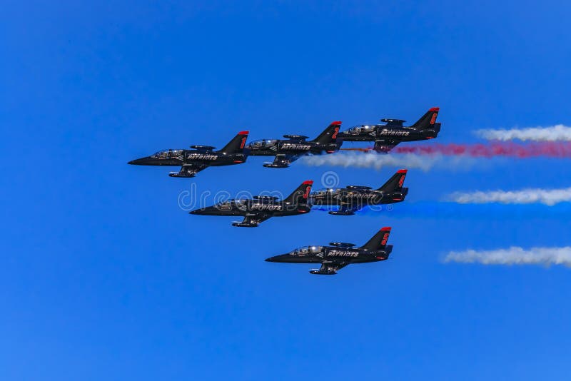 Patriots Jet Team aerobatic team Aero L-39 Albatros jets in formation with colorful contrails, San Francisco Fleet Week