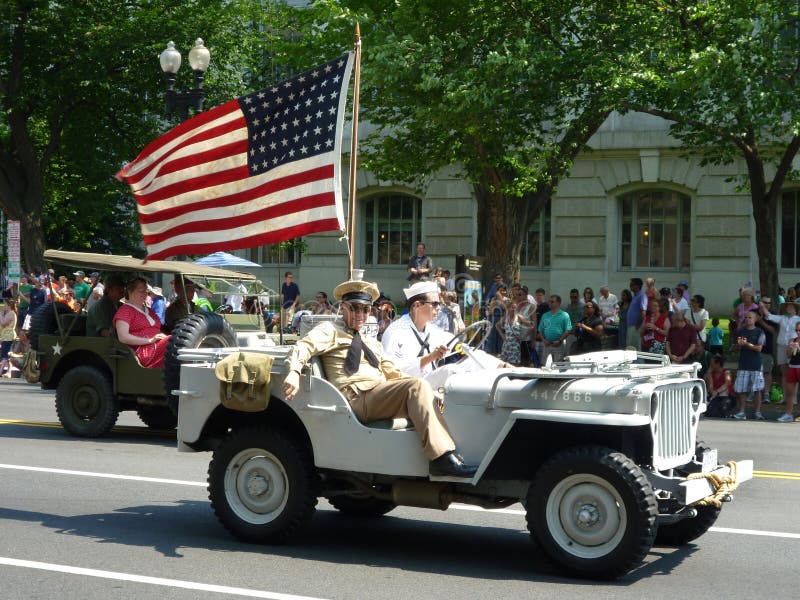 Photo of wwii jeep with american flag and military men dressed in wwii clothing during the memorial day parade in washington dc on 5/30/11. Photo of wwii jeep with american flag and military men dressed in wwii clothing during the memorial day parade in washington dc on 5/30/11.