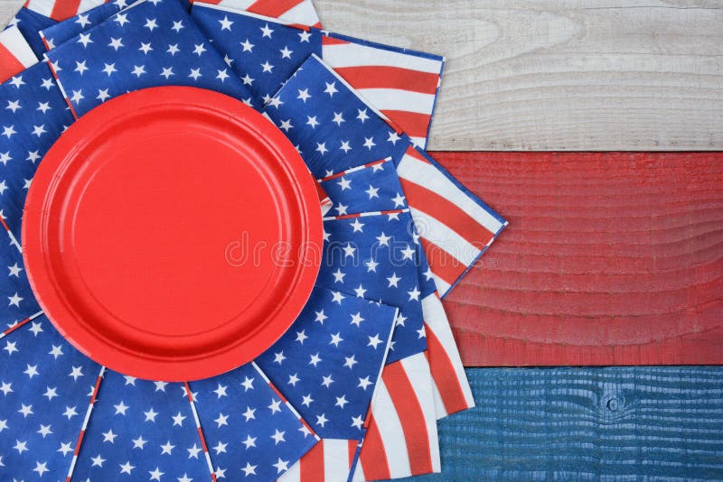 High angle shot of American Flag napkins on a red, white and blue picnic table. Horizontal format with copy space. Suitable for American Holidays: 4th of July and Memorial Day, and Veterans Day. High angle shot of American Flag napkins on a red, white and blue picnic table. Horizontal format with copy space. Suitable for American Holidays: 4th of July and Memorial Day, and Veterans Day.