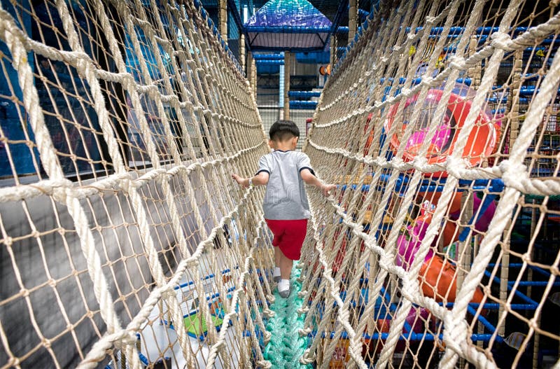 PATTAYA, THAILAND - NOVEMBER 21: A boy makes his way across a br