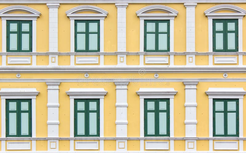 Pattern green vintage style window on yellow wall