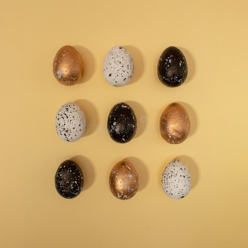 Pattern made of colored eggs on pastel beige background. Minimal Easter concept stock images