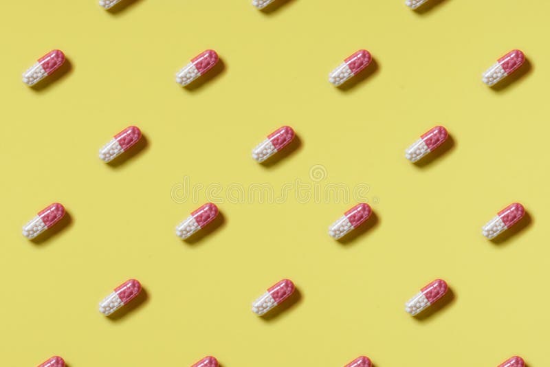 Pattern of Pink and White Pills on a Yellow Background. Hard Light