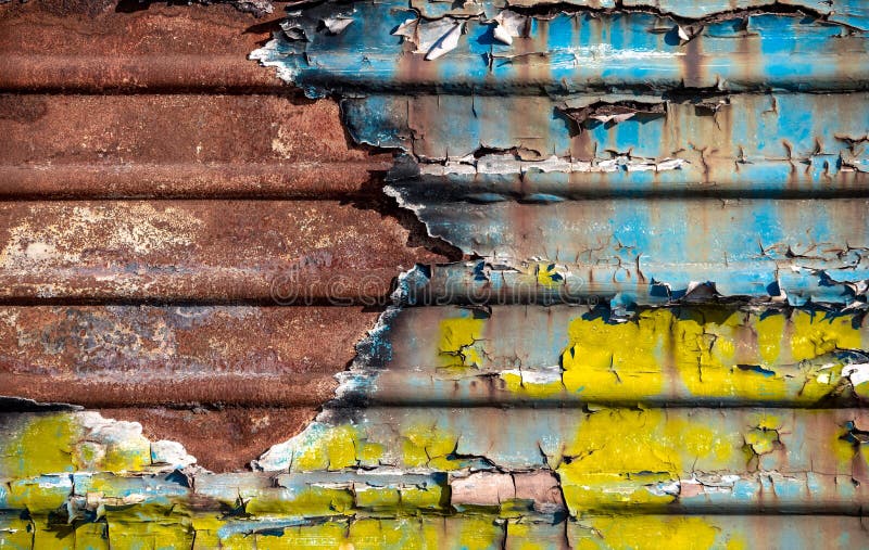 Pattern Rusty Metal Surface with Remnants of Blue and Yellow Paint