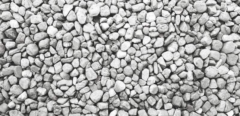 Pattern of small gravel, rock or stone on the ground for background in black and white color tone