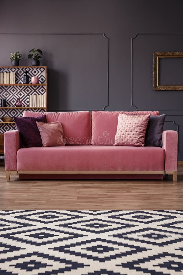 Patterned Rug in Front of a Pink Sofa with Pillows in an Elegant Stock Photo Image of flat