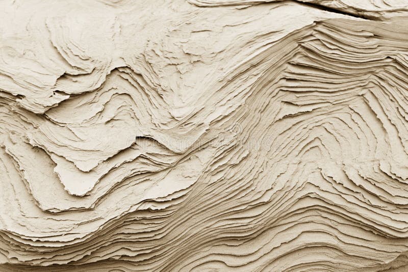 Patterns of erosion of sand in the background