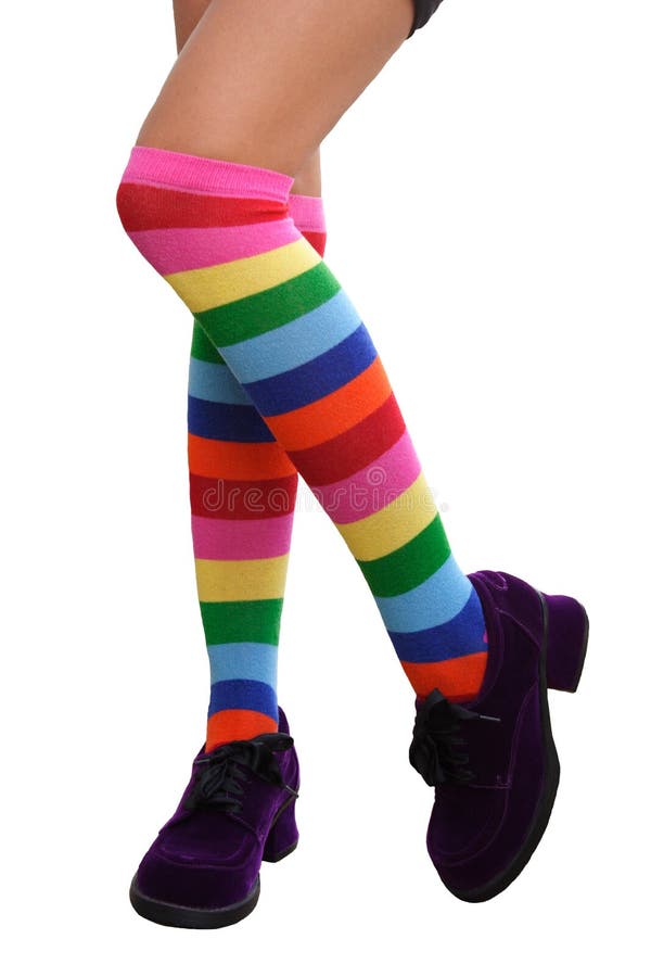 Pretty legs in a crazy combination of multi-colored striped knee-his & chunky purple suede shoes. Isolated. Pretty legs in a crazy combination of multi-colored striped knee-his & chunky purple suede shoes. Isolated.