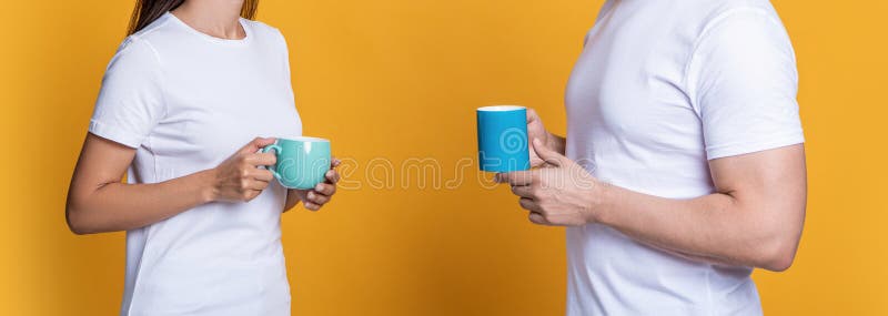 Coffee break at home. Family couple having coffee isolated on yellow. Morning coffee time. Couple of man and woman drinking tea. Family day together. Warm relationship. Lazy weekend. Coffee break at home. Family couple having coffee isolated on yellow. Morning coffee time. Couple of man and woman drinking tea. Family day together. Warm relationship. Lazy weekend.