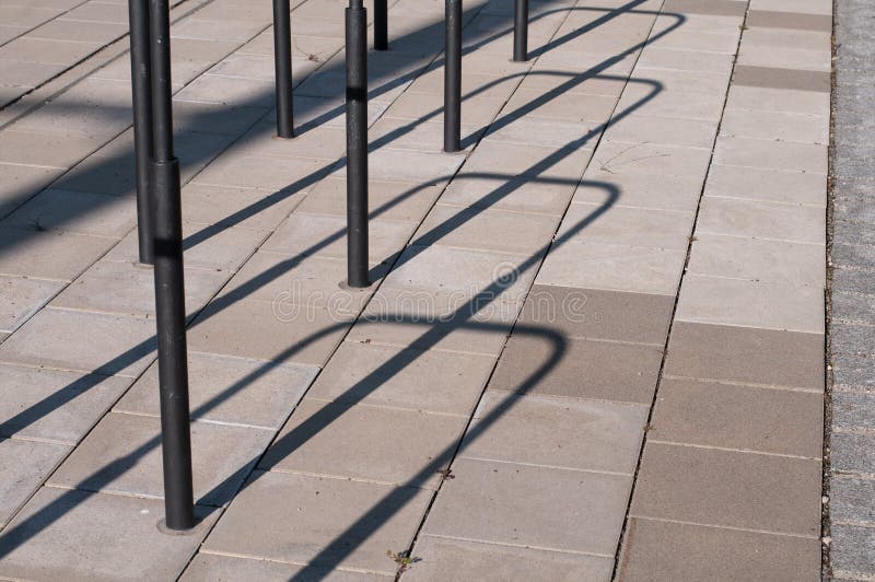 Bicycle Racks Casting Shadows on a Sidewalk Stock Photo Image of