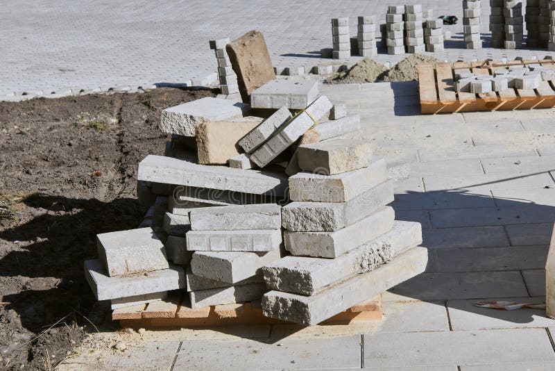 Pavement. Laying gray concrete paving slabs. Construction Site. stock photo