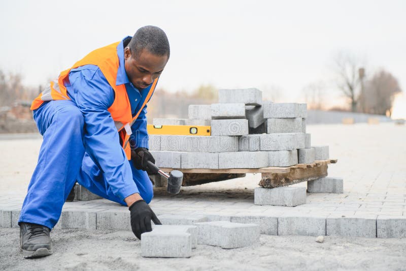 Pavement. Laying paving stones. Cube, openwork plate stock photography