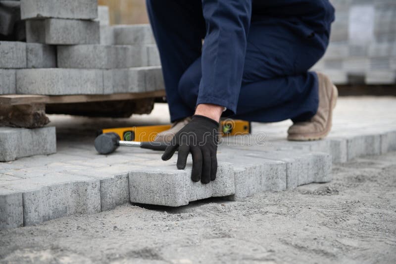 Pavement. Laying paving stones. Cube, openwork plate stock images