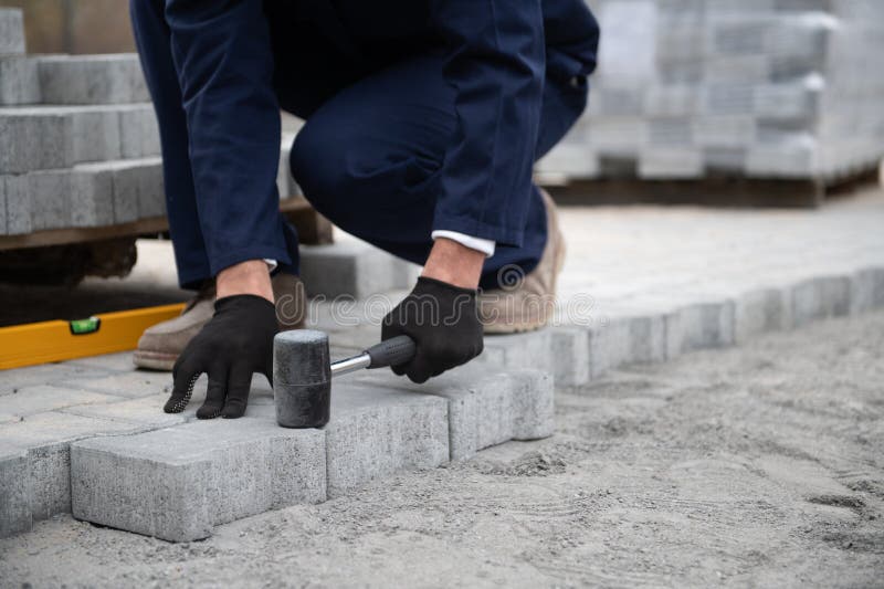 Pavement. Laying paving stones. Cube, openwork plate royalty free stock images