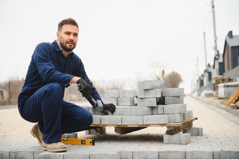 Pavement. Laying paving stones. Cube, openwork plate stock photography